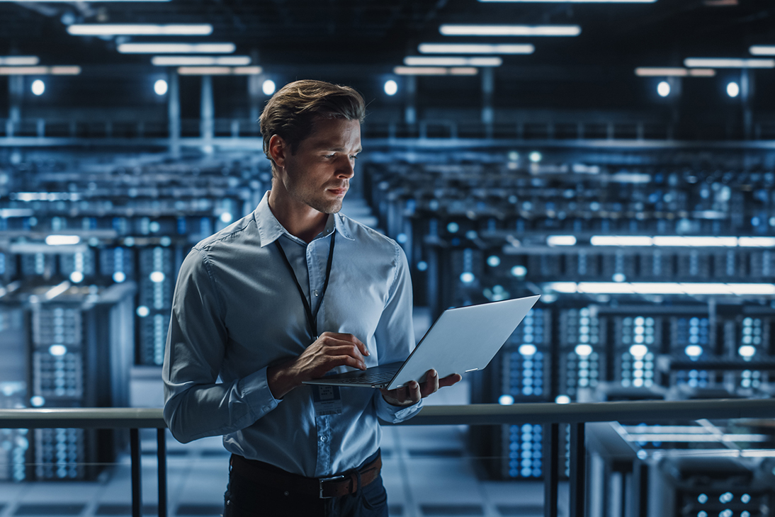 IP-Line man looking over a computer