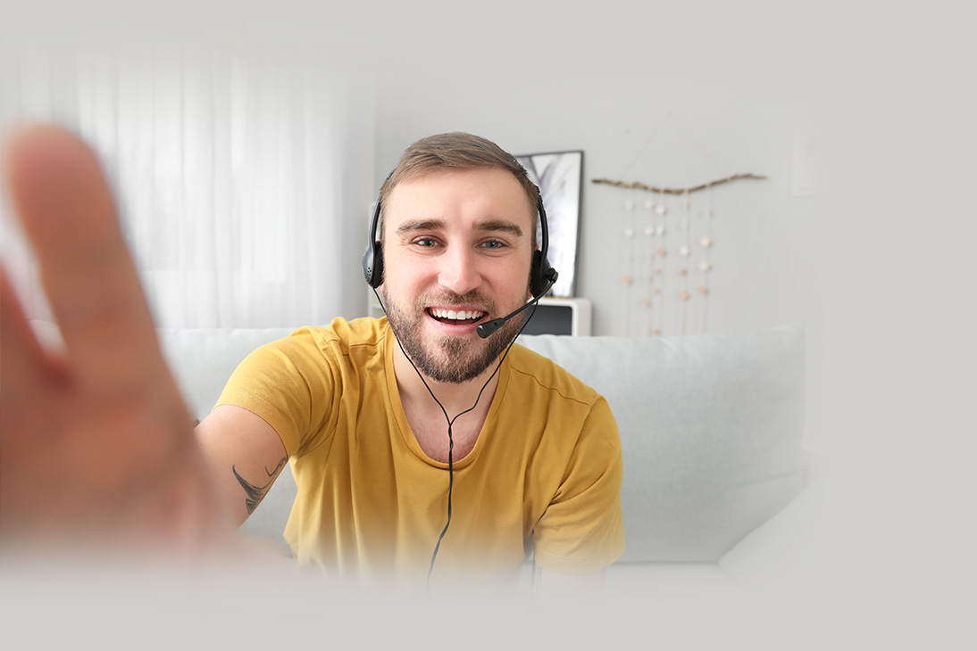A guy smiling with a headset